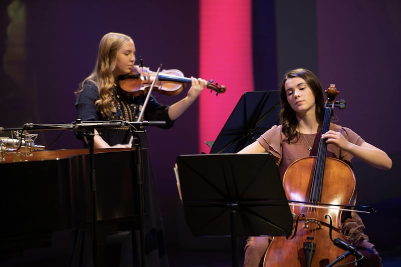 Mia Bateman and Karina Miner play musical instruments on Sunday, November 15, 2020, as part of the Face to Face broadcast for young women that celebrates 150 years since the Church organization for that age group met for the first time. Before the event, the Young Women General Presidency invited current and previous members of the young women organization to share how their leaders blessed their lives on social media.