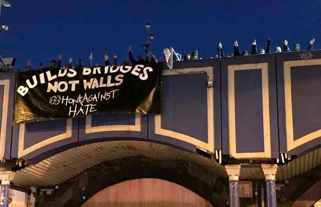 Group of young people with banner in street protest