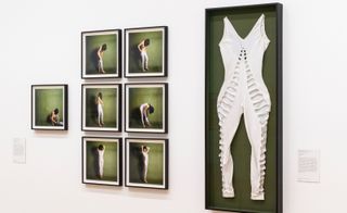 Framed clothing and images on wall at ‘Women in Revolt!’ exhibition