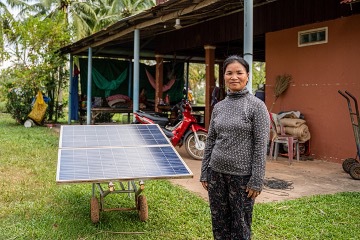 Duek Da stands next to her solar power