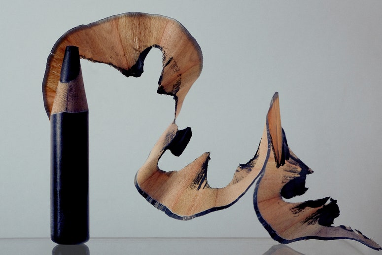 A black eyeliner pencil sharpened to the bottom with pencil shavings.
