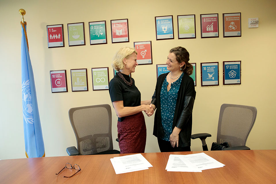 UN Women Deputy Executive Director Åsa Regnér and Executive Director of Fondation CHANEL shake hands. Photo: UN Women/Ryan Brown