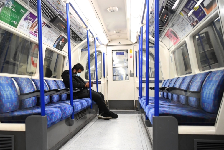 LONDON, ENGLAND - MAY 07: A member of the public wears a protective mask on the Northern Line on May 07, 2020 in London, England . The UK is continuing with quarantine measures intended to curb the spread of Covid-19, but as the infection rate is falling government officials are discussing the terms under which it would ease the lockdown. (Photo by Alex Davidson/Getty Images)