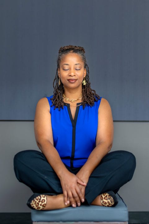 Professor Stephanie Y. Evans, a Black woman, practicing yoga as a form of self-care