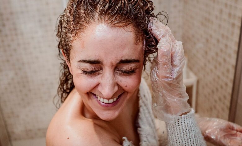 Woman applying hair treatment facebook x.jpg