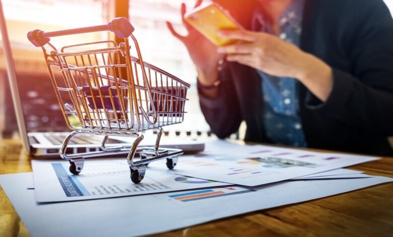 cropped image woman inputting card information key phone laptop while shopping online min .jpg