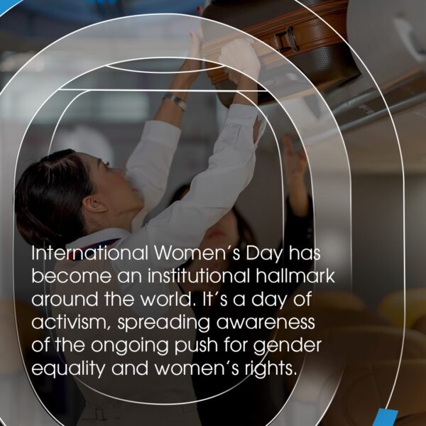 A photograph of a crew member helping a passenger to place their bag in the overhead bin. The image shares a quote: International women's Day (IWD) has become an instiutional hallmark around the world. it's a day of activism, spreading awareness of the ongoing push for gener equality and women's rights. 