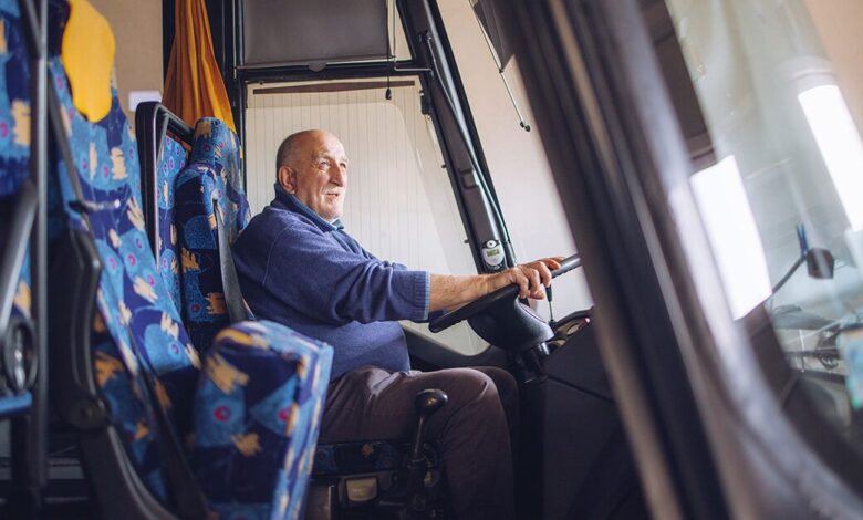 senior male bus driver behind the wheel x facebook x.jpg